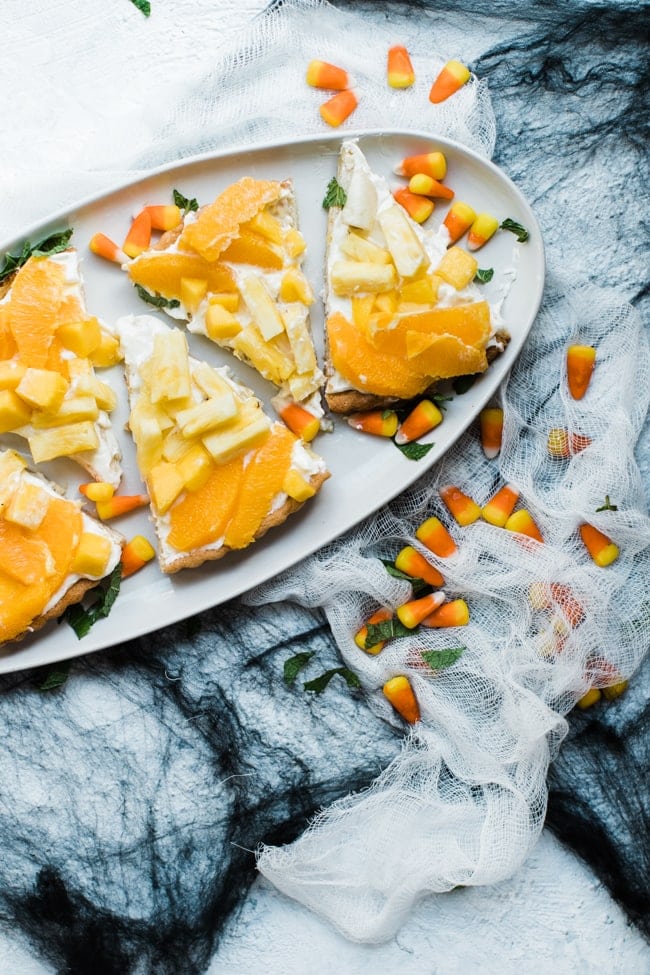 Candy corn fruit pizza slices on a platter