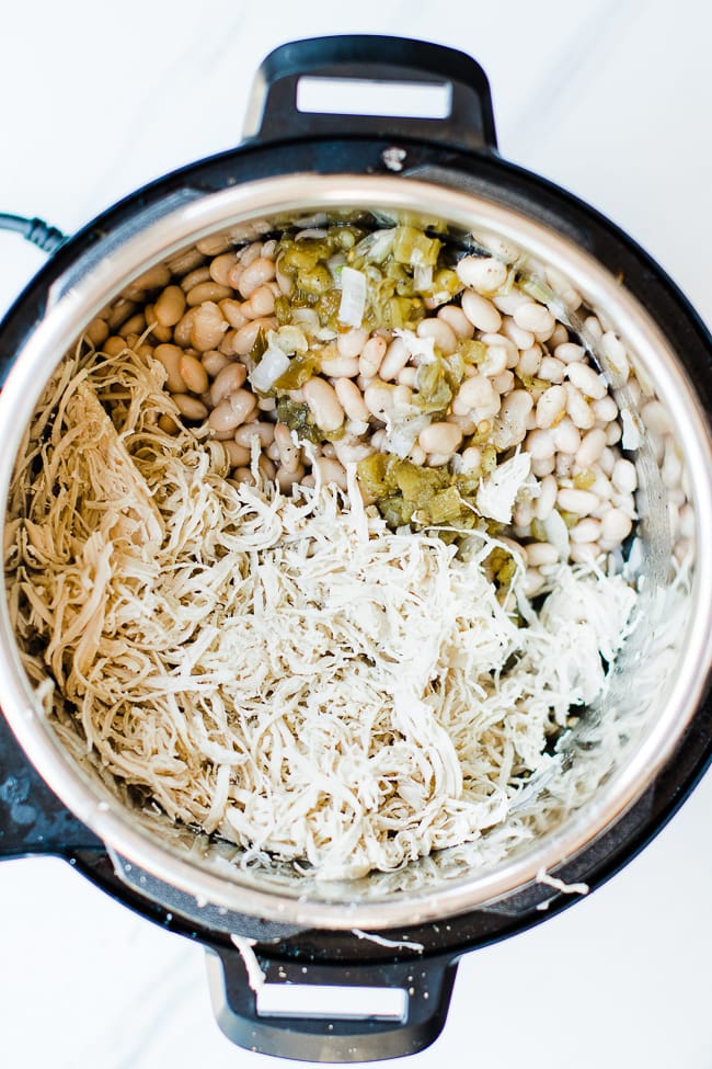 all ingredients, chicken, broth, beans, green chili's in instant pot