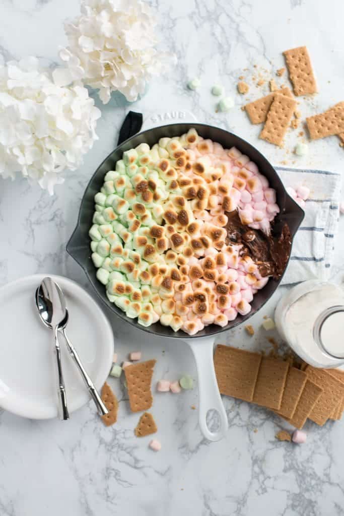 An overhead shot of unicorn smores in a skillet pan