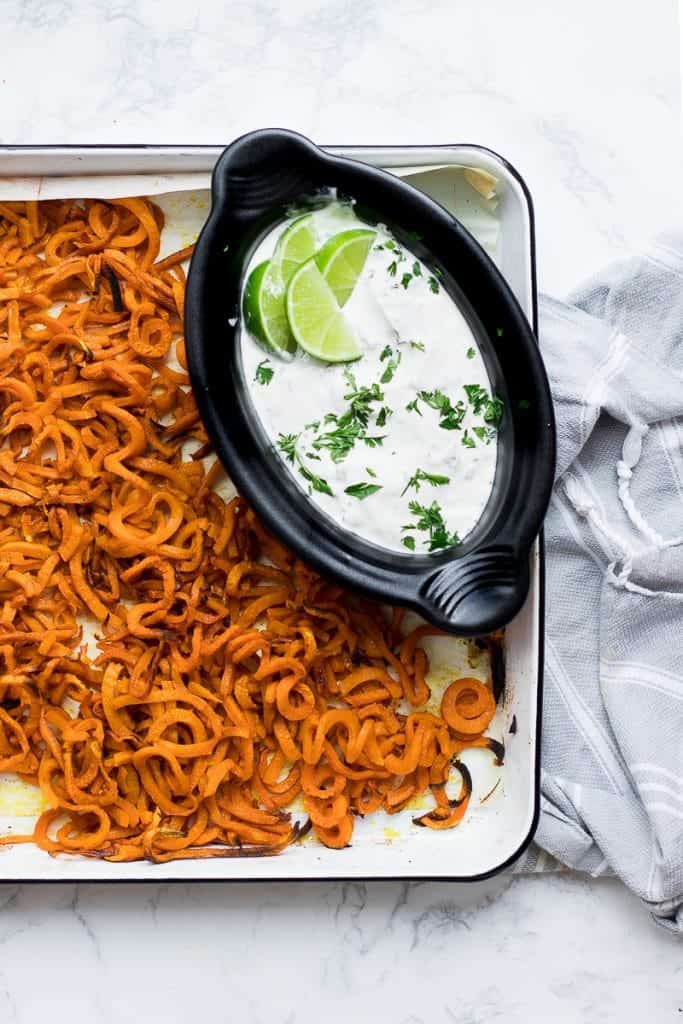 Baked Curly Sweet Potatoes and a Cilantro Lime Dip on a tray