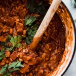 baked beans in dutch oven with wooden spoon
