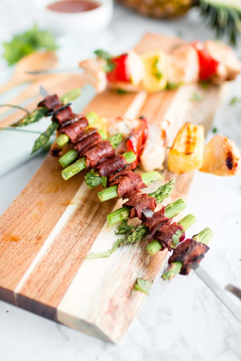 A close up of Bacon wrapped asparagus kabobs