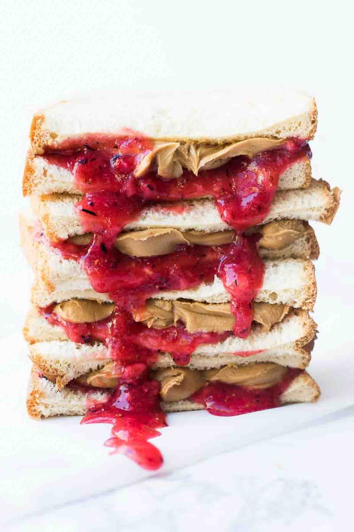 A stack of homemade jam and peanut butter sandwiches