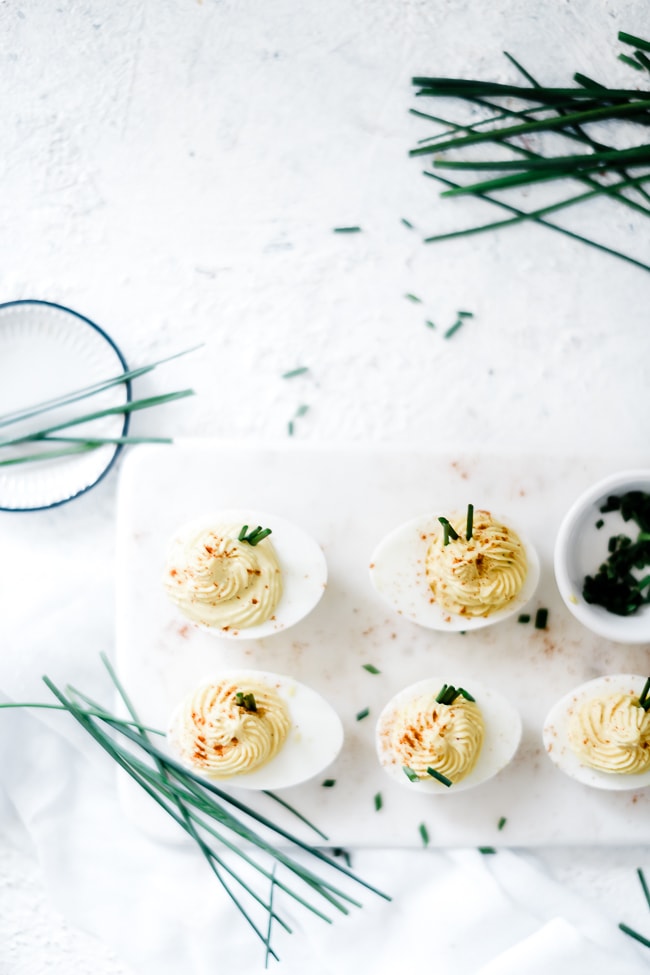 The best deviled eggs on a marble serving tray.