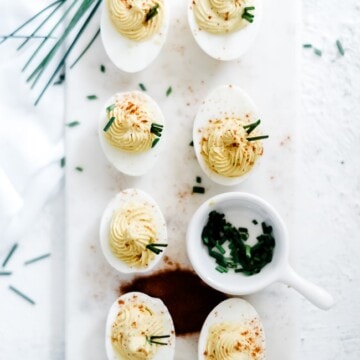 The best deviled eggs recipe on a marble cutting board.