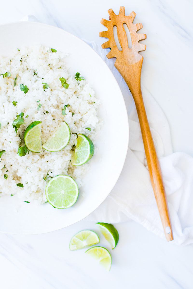 Cilantro Lime Rice in a white bowl with a serving spoon