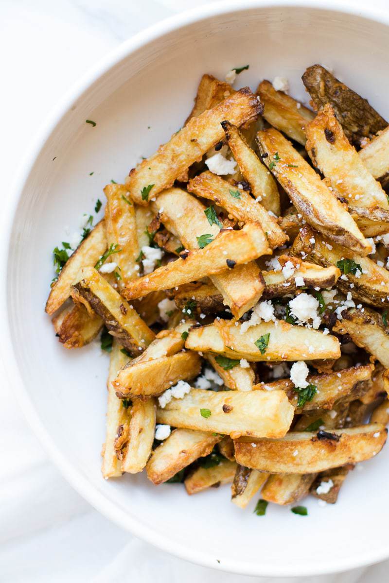 Garlic Parmesan Fries in a bowl topped with herbs