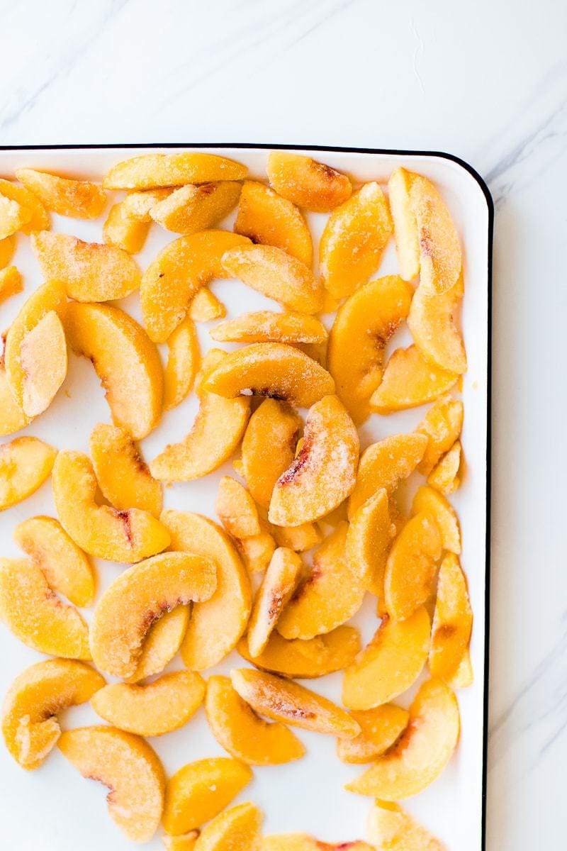 A tray of peaches used to make a Peach Cobbler Smoothie