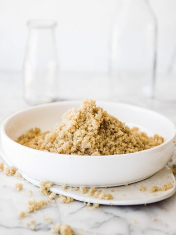 white quinoa in a white bowl with white backgound