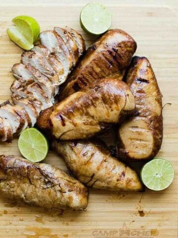 Chicken breasts cooked in lime chicken marinade on a cutting board.