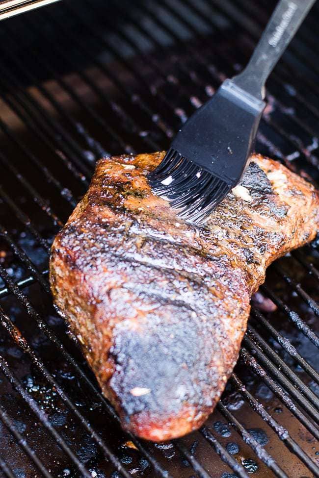 silicone brush basting tri-tip on grill