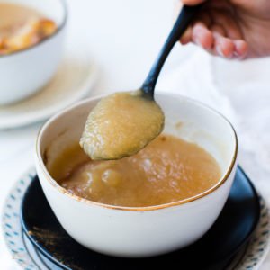 smooth applesauce in bowl with spoon