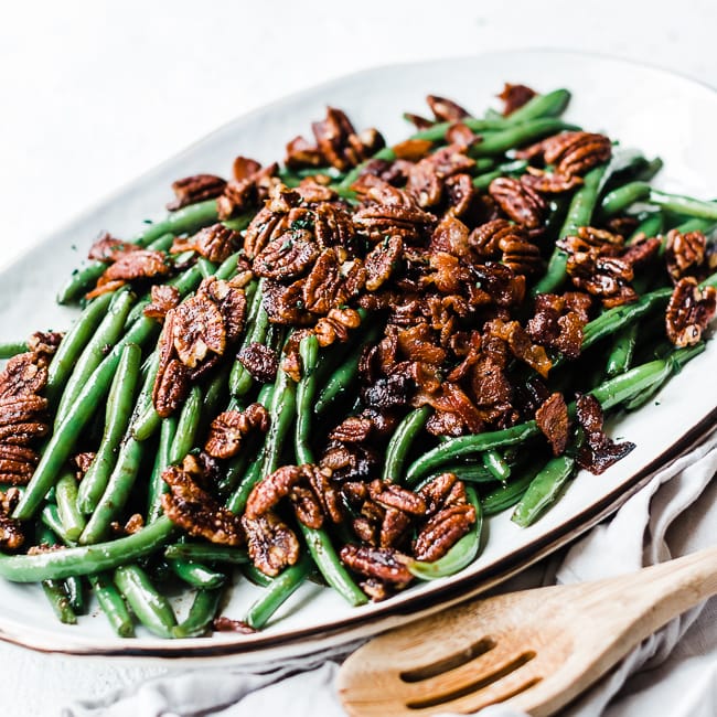 Candied Green Beans - on a white platter atop a grey napkin.