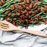 Candied Green Beans - on a white platter atop a grey napkin.