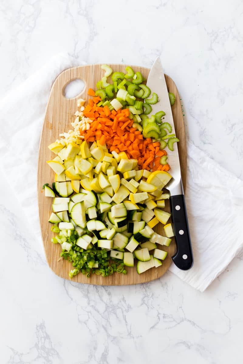 chopped veggies on chopping board with knife