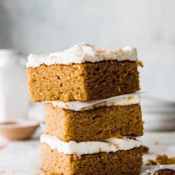 Three slices of pumpkin cake stacked on top of each other.