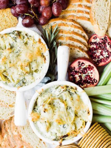 platter of crackers with hot spinach artichoke dip