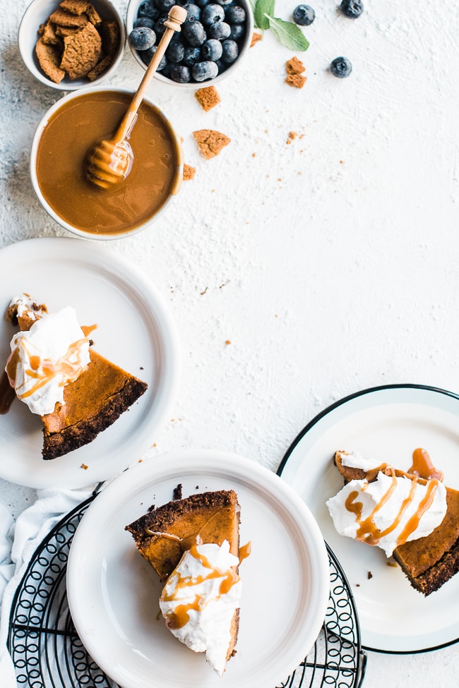 Pumpkin pie with gingersnap crust - on white plates.