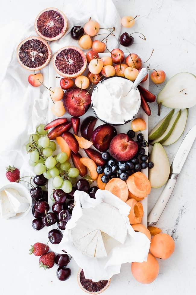 platter of fruit and a small bowl of fluffy fruit dip