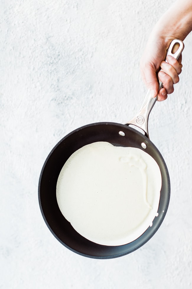 frying pan with crepe spread on out