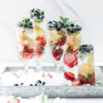 Red white and blueberry summer mocktail in champagne glasses.