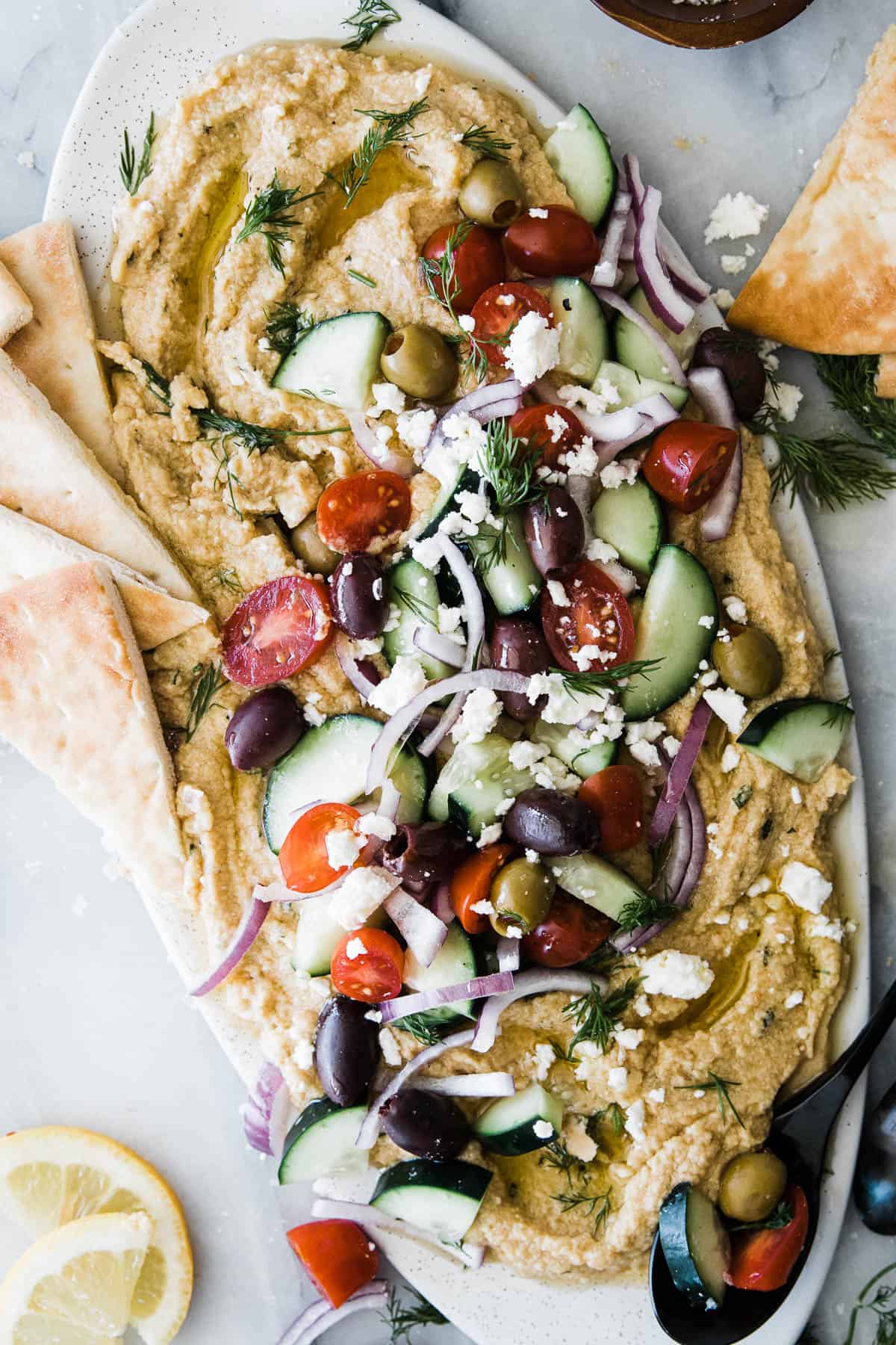 Hummus loaded with greek toppings such as kalamata olives, cucumber, tomatoes, red onion and dill. 