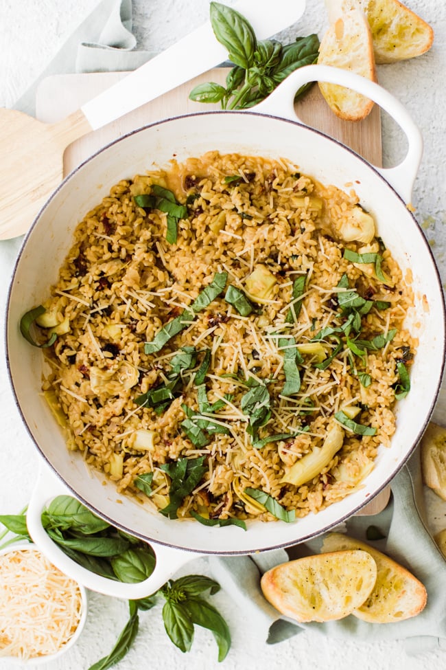 large circular pan with risotto topped with basil