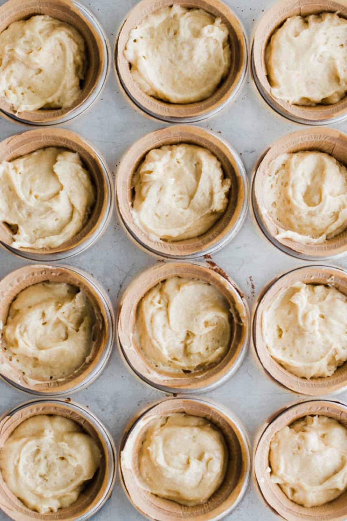 Buttermilk banana batter in muffin containers. 