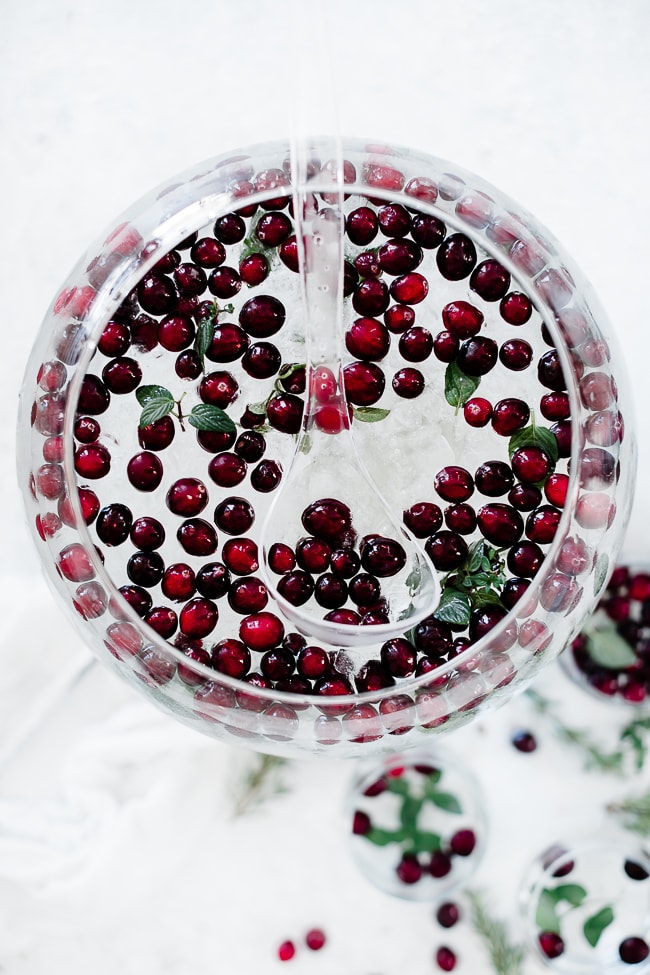 Cranberry mint water in a glass punch bowl.