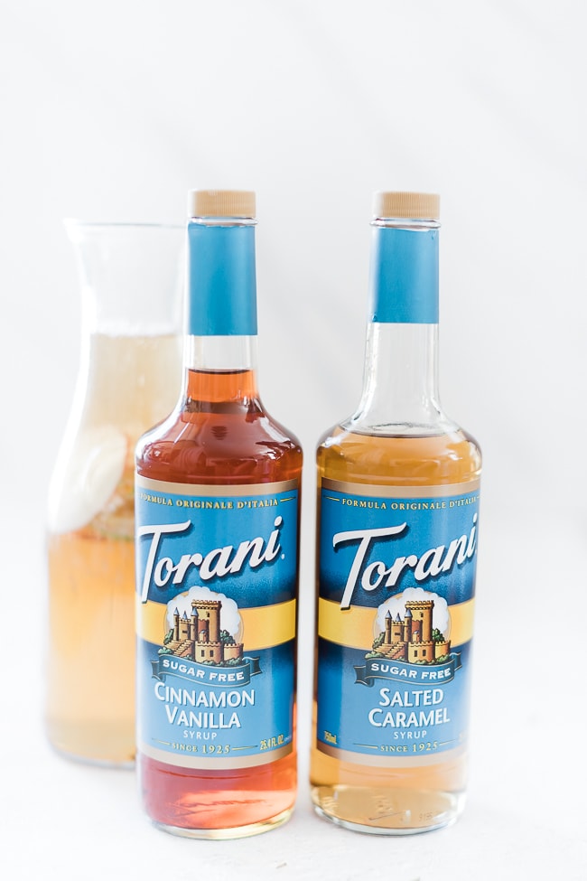 Torani syrups in front of sparkling apple punch.