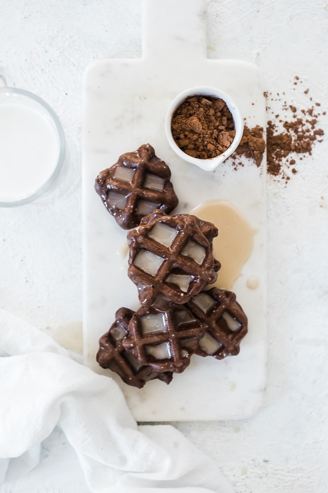 Chocolate waffle cookies on a marble cutting board.