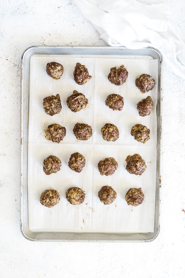 Meatballs cooked on a baking sheet.