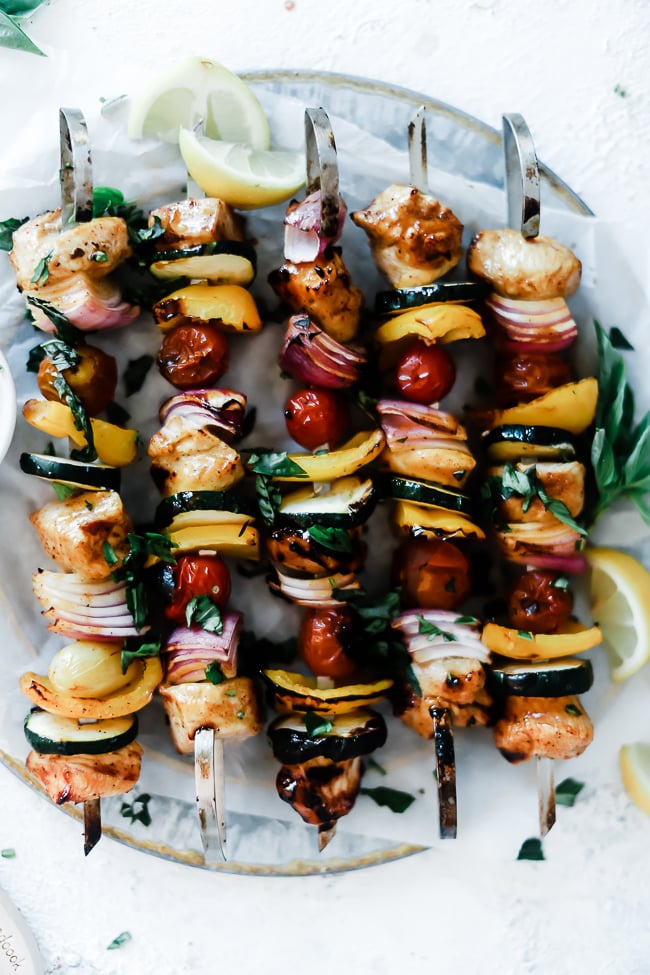 A close-up shot of honey mustard kabob marinade recipe. Skewers mare lined up on a metal platter.