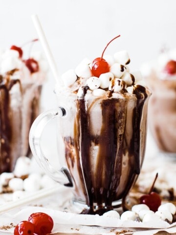 3 mugs of frozen hot chocolate topped with marshmallows drizzled with chocolate syrup