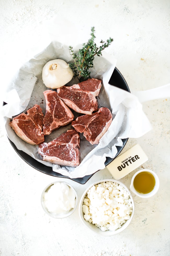 Ingredients needed to make Easy Lamb Chops Recipe: lamb chops, garlic, thyme, butter, sour cream, feta, and olive oil.