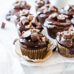 A closeup of chocolate peanut butter cupcakes.