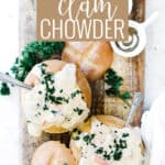 Pin for pinterest graphic with creamy clam chowder in a bread bowl and text on top.