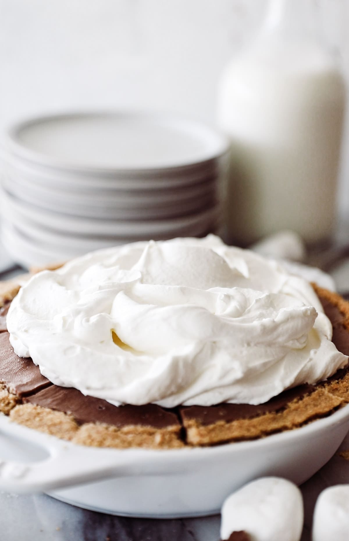 Chocolate cream pie with whipped cream topped high. 