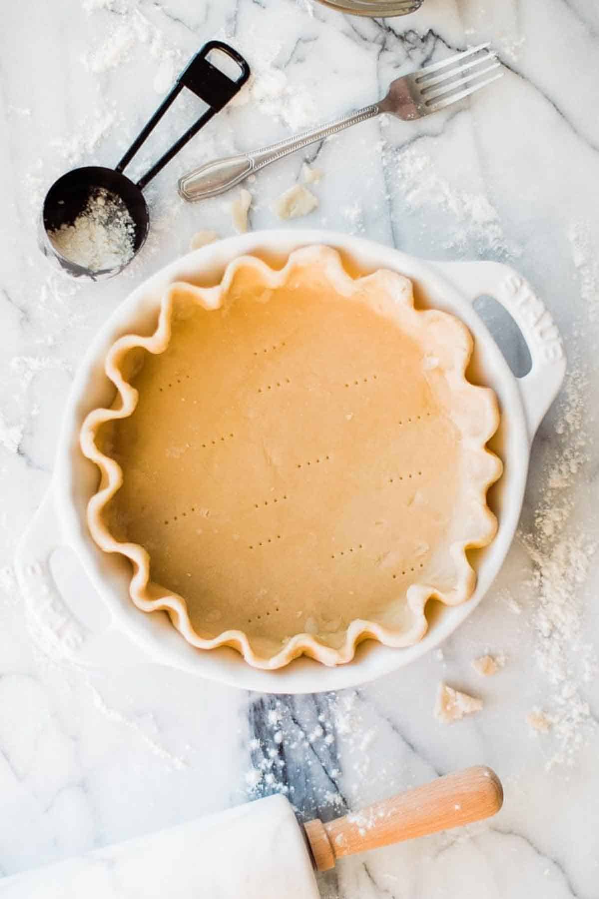 A simple pie crust in a baking dish ready to fill.