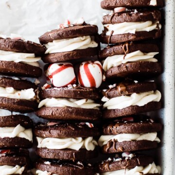 peppermint oreo cookies stacked in tray with peppermints