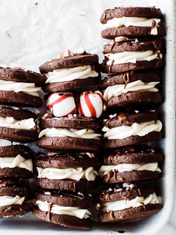 peppermint oreo cookies stacked in tray with peppermints