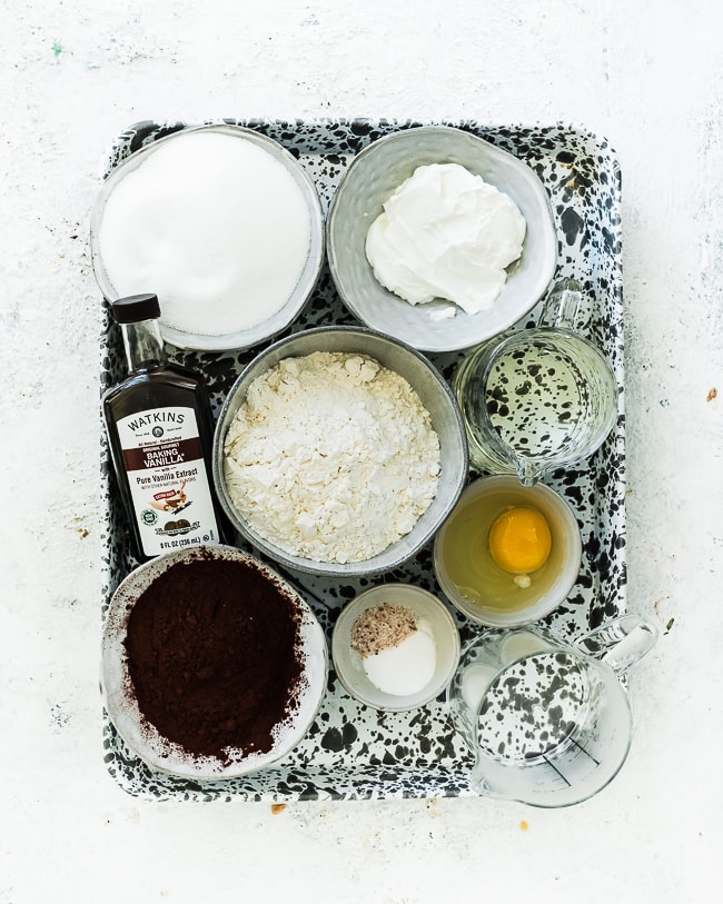 Ingredients needed to make chocolate cake on a baking tray.