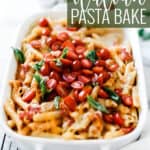 Pin for pinterest graphic with penne pasta bake in a casserole dish with tomatoes and basil on top.