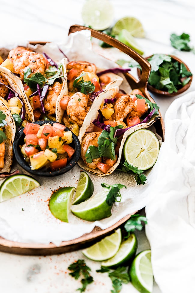 A half shot of a tray of grilled shrimp tacos