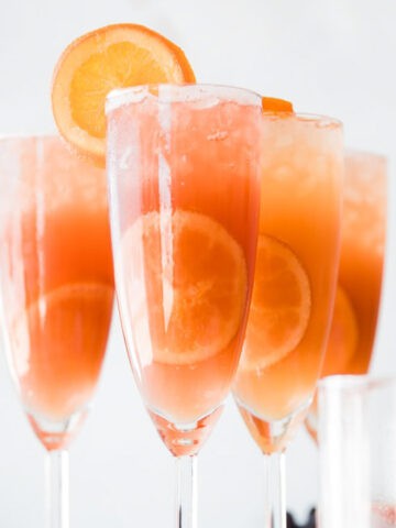 Best mimosa mocktails on the table with orange slices.