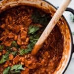 A pot of best baked beans garnished with parsley.