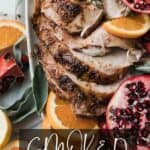 Sliced of juicy smoked turkey on a platter with oranges, herbs and pomegranates.