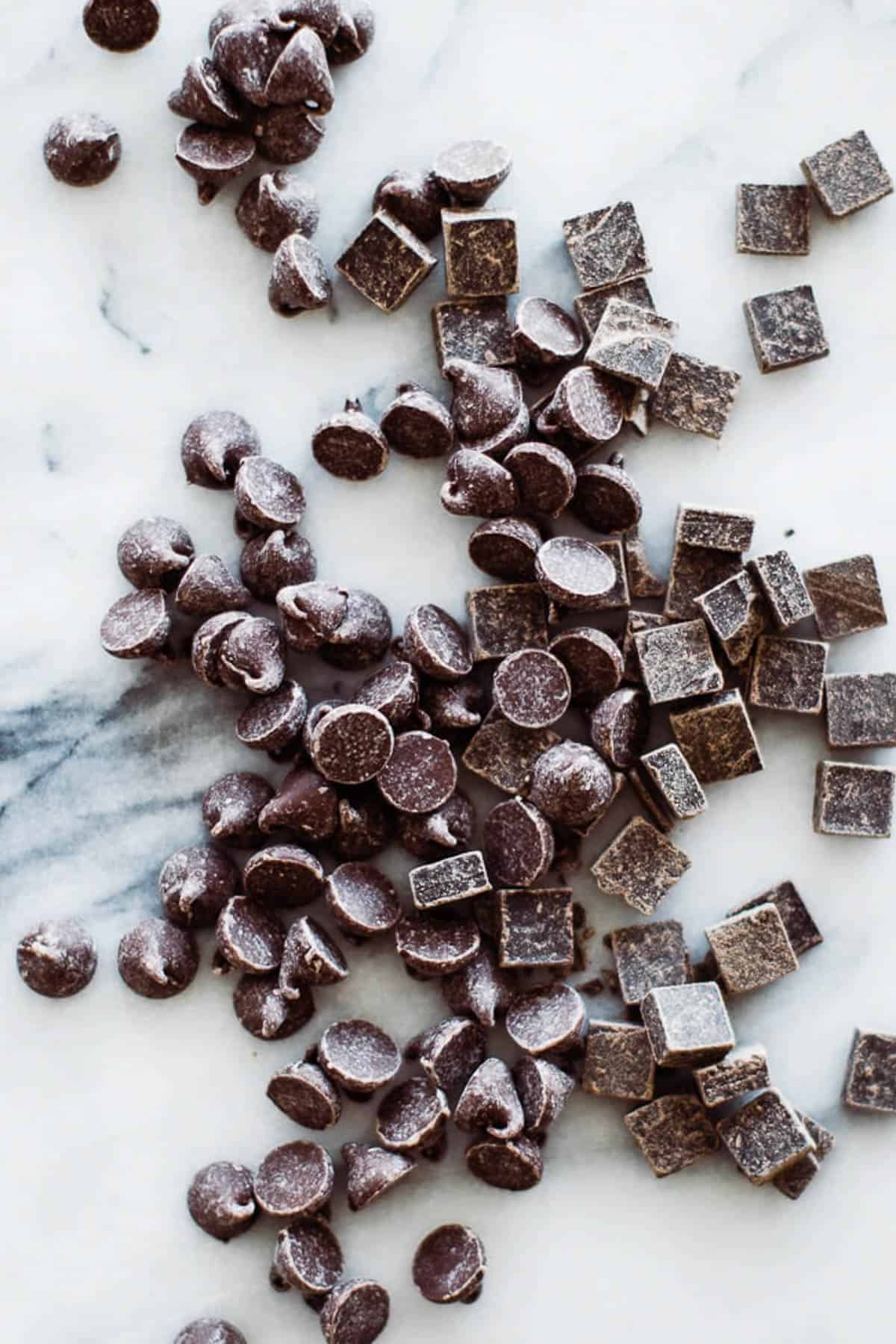 variety of chocolate chips on marble board.