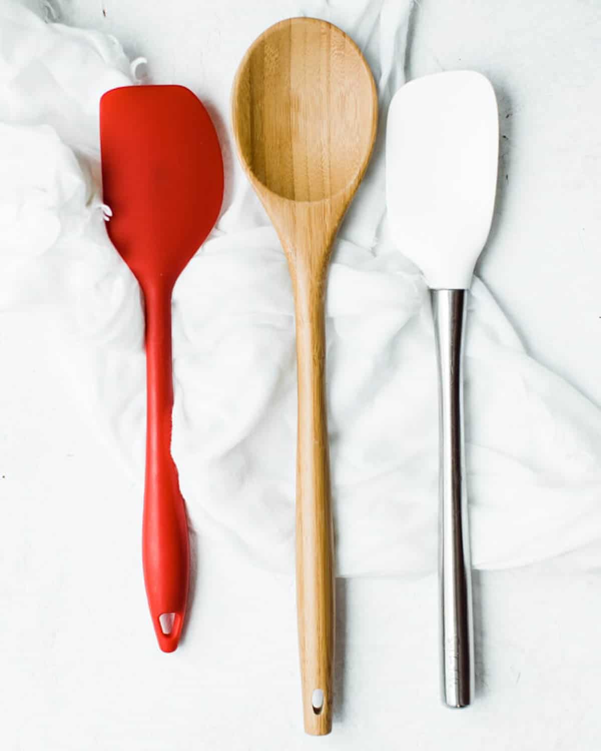 Silicone and wood spatulas shown on a napkin.