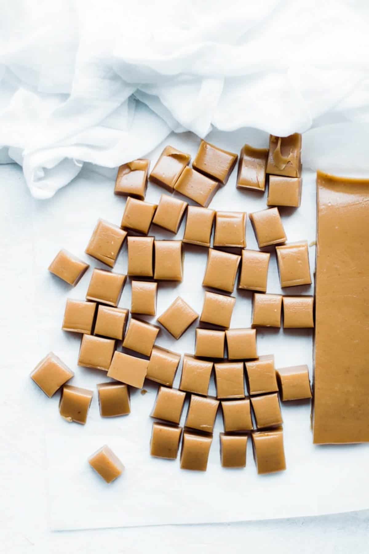 Caramel from pan being cut into squares.